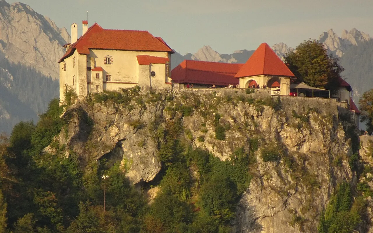 Bled Castle on its cliff above Lake Bled in evening light